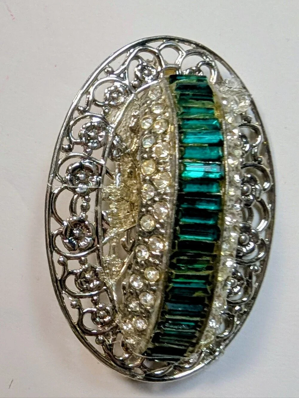 Wendy Gell pin silver filigree brick base with Emerald baguette shape.